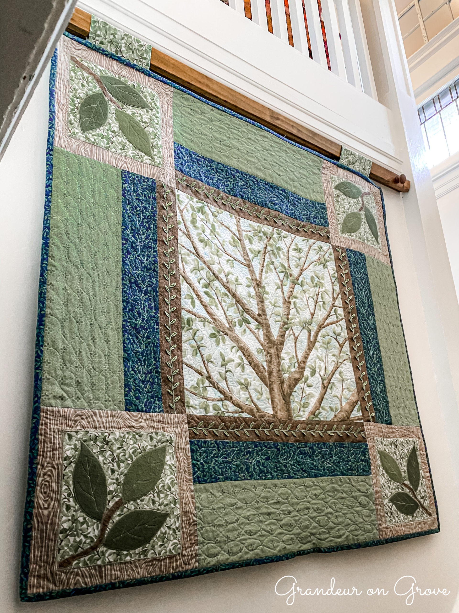 Quilted wall hanging with a tree theme
