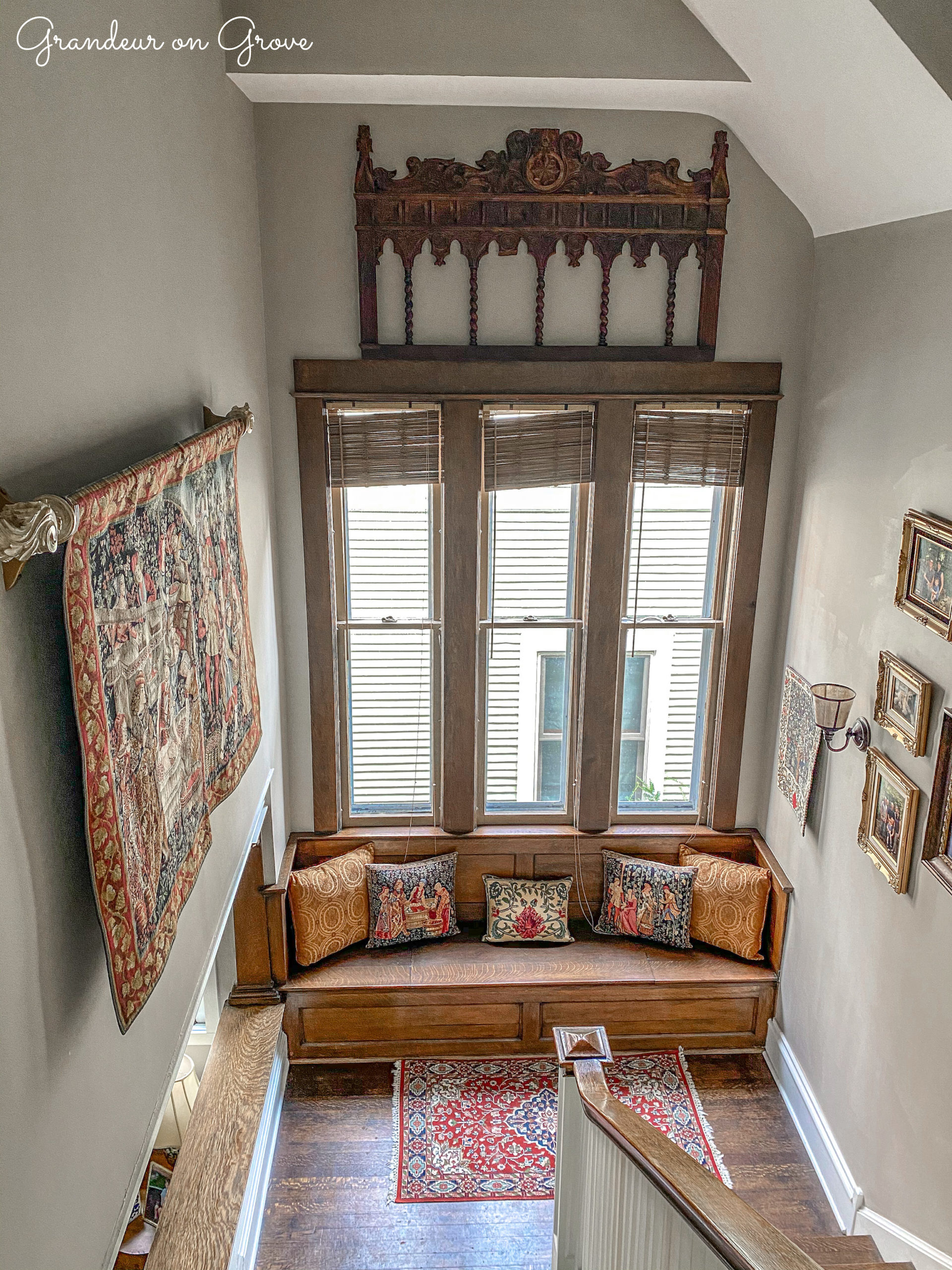 Headboard decoratively displayed high above tall windows in a stairway