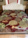 The finished quilt with a center seam on a king-sized bed