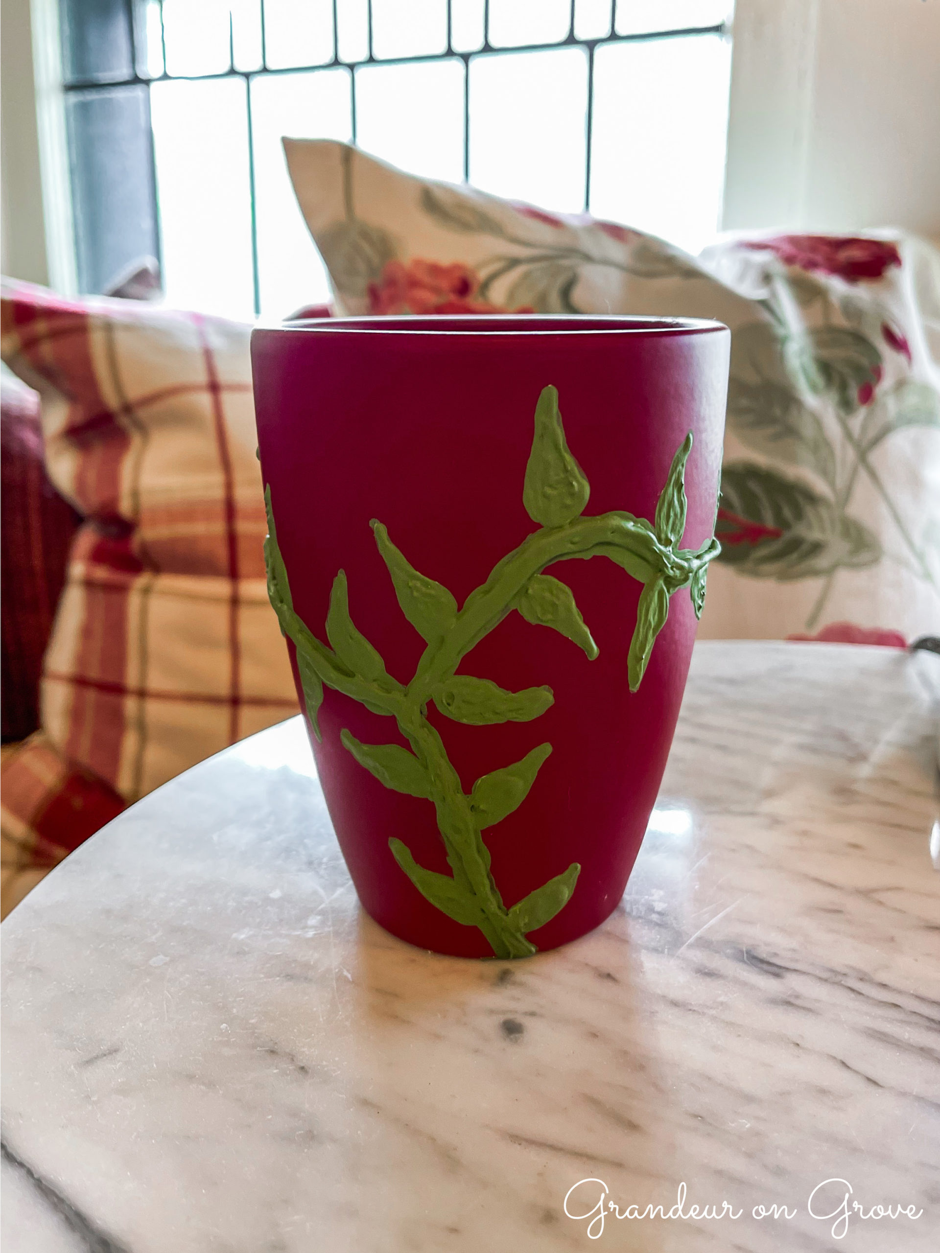 red pot with green vines